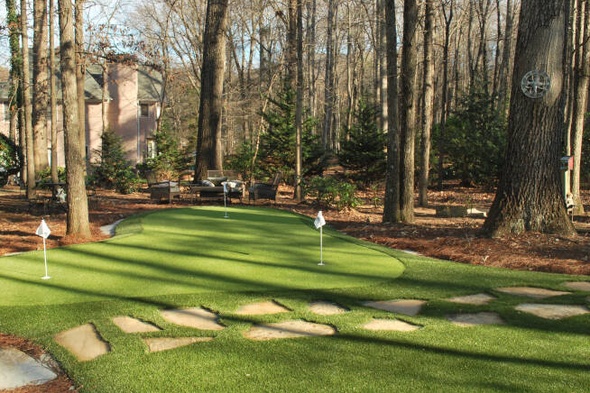 Asheville backyard putting green with flags and trees